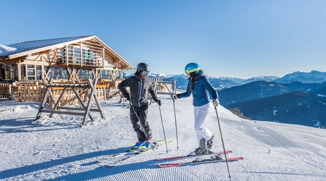 Narciarze przy schronisku narciarskim na stoku Plan de Corones w Dolomitach