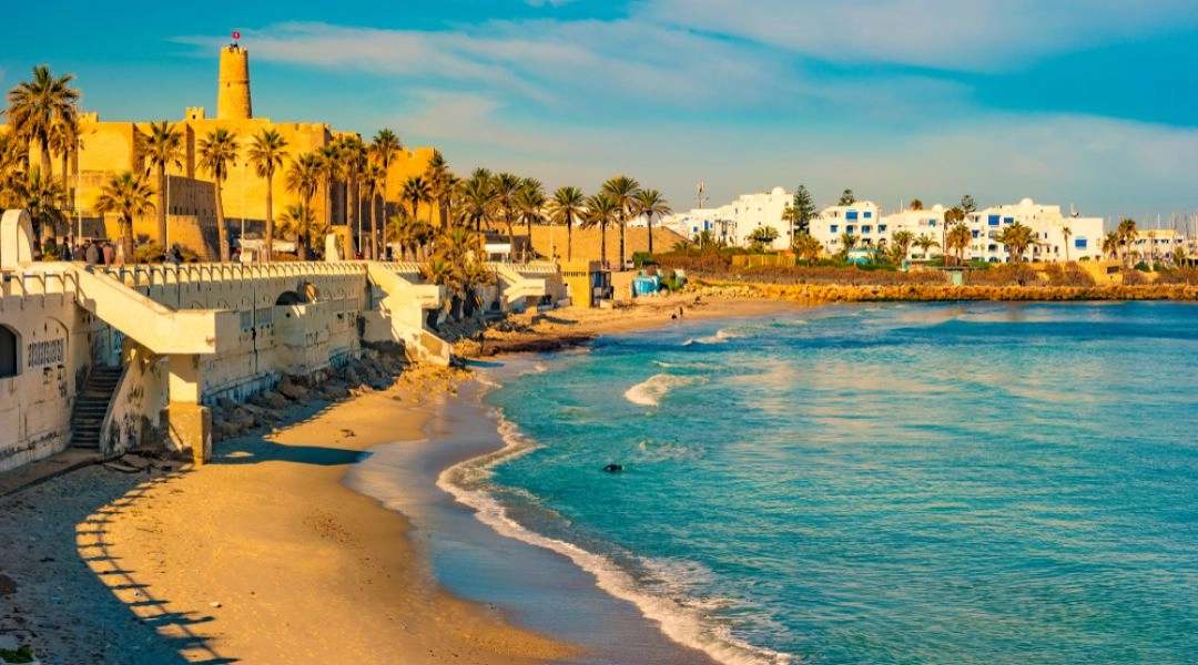 Nadmorska promenada z murami i palmami w Tunezji.