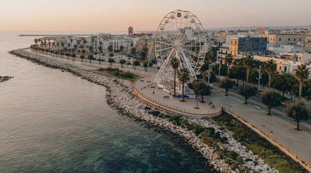 Nadmorska promenada i diabelski młyn w Bari o zachodzie słońca