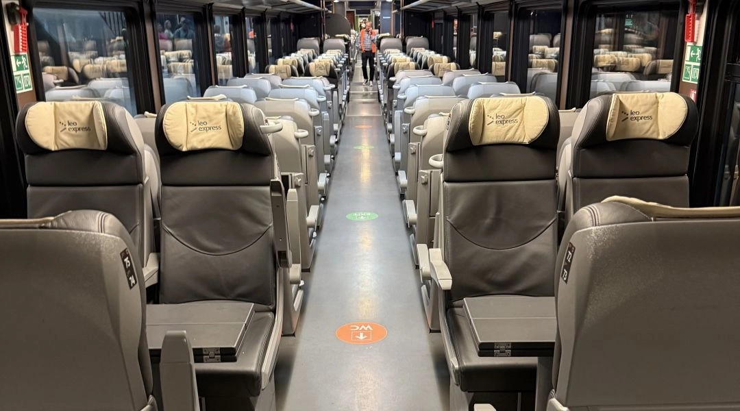 Wnętrze pociągu Leo Express – wagon pasażerski z wygodnymi fotelami i przejściem między siedzeniami