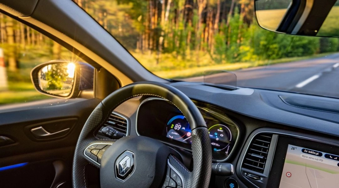 Wnętrze samochodu renault clio z widokiem na kierownicę i przednia szybę