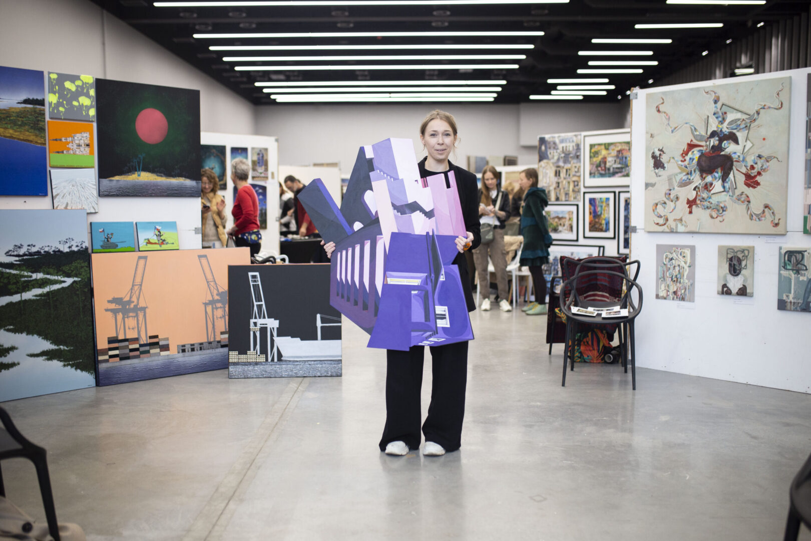 Artystka prezentująca swoje obrazy na stoisku podczas Targowiska Sztuki w Centrum Praskim Koneser