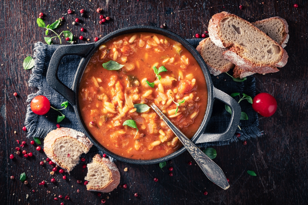 Sardyńska minestrone w żeliwnym garnku z warzywami i fasolą, podawana z chlebem