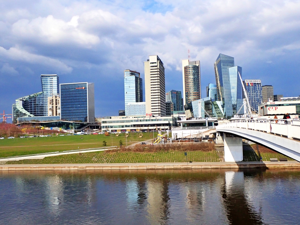 Panorama nowoczesnej dzielnicy biznesowej w Wilnie nad rzeką Wilią, widok na wileński Manhattan i Most Biały.